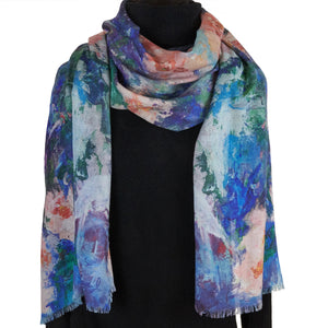 Long cashmere-silk scarf with floral design by Oksana Fine Art and Design, based on an impressionist painting of pink orchids with a light green and blue background, worn over a black sweater. 210x70 cm, 82x27 inches