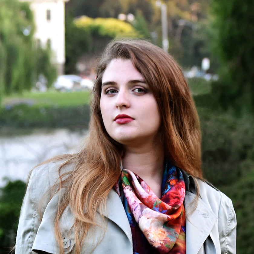 Young woman outdoors with 100% silk scarf made in Italy, designed by Oksana Johnson 