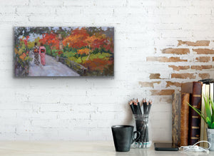 Original oil painting by Oksana Johnson of two women in traditional Japanese kimonos walking in an ornamental park with autumn leaves and other fall foliage. On a painted brick wall above a desk with pencils and books.
