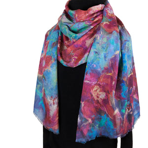Long cashmere-silk scarf with floral design by Oksana Fine Art and Design, based on an impressionist painting of red orchids with a green and turquoise background, worn over a black sweater. 210x70 cm, 82x27 inches